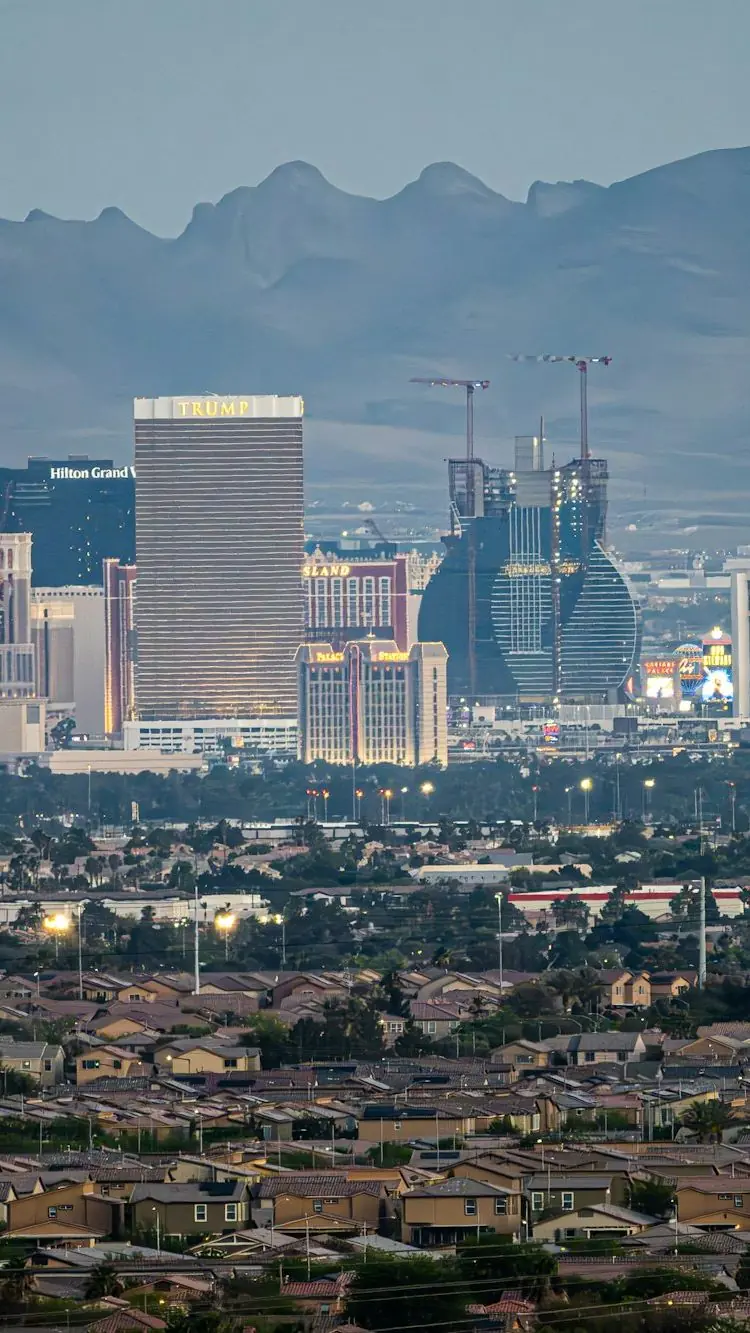 The Las Vegas Strip at dusk, its towers stacked against dark mountains